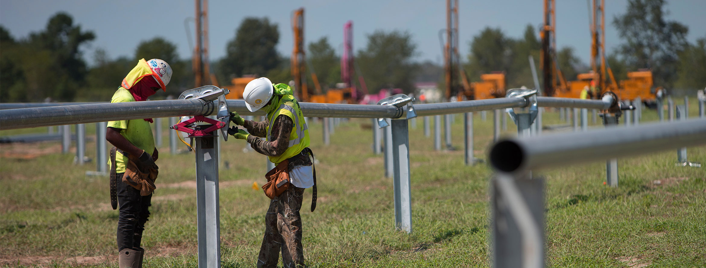 Solar workers on a solar farm construction site.