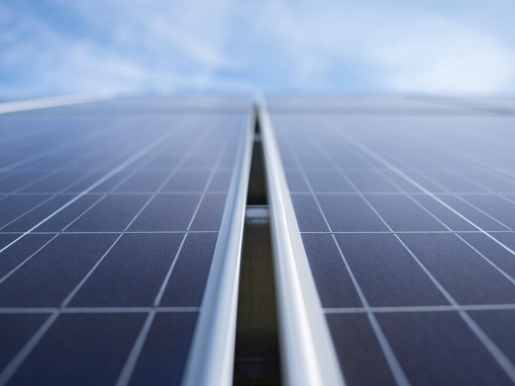 An extreme close up of a solar panel against a blue sky