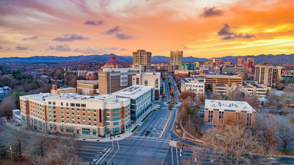 A aerial of a city skyline at sunset