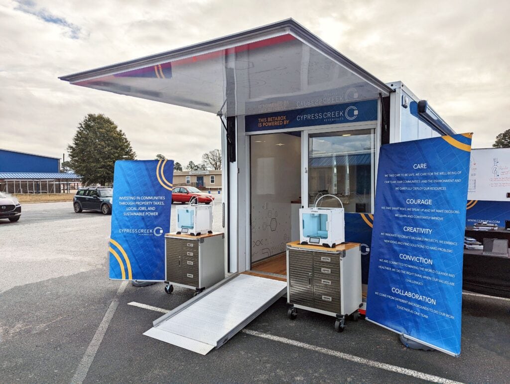 One end of a shipping container used for STEM education is shows with Cypress Creek branding